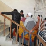 Group-of-volunteers-taking-one-of-the-new-instruments-to-a-classroom.