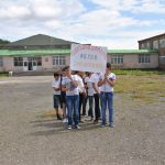Children who attend the Ljashen Village School holding up a sign thanking The Paros Foundation.